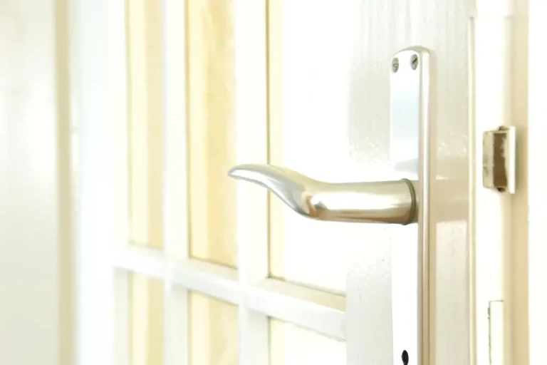 How to change a uPVC door lock in Wilmslow – white door with a lever handle on a long backplate, Locksmith Wilmslow guide to barrel, handle and multipoint replacement