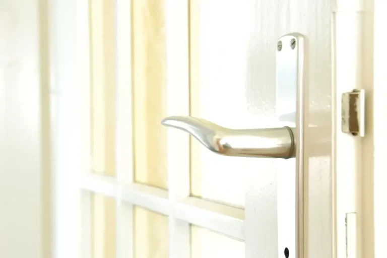 Lock repair or replacement in Wilmslow – white door with a lever handle and locking plate, Locksmith Wilmslow guide to which your door needs