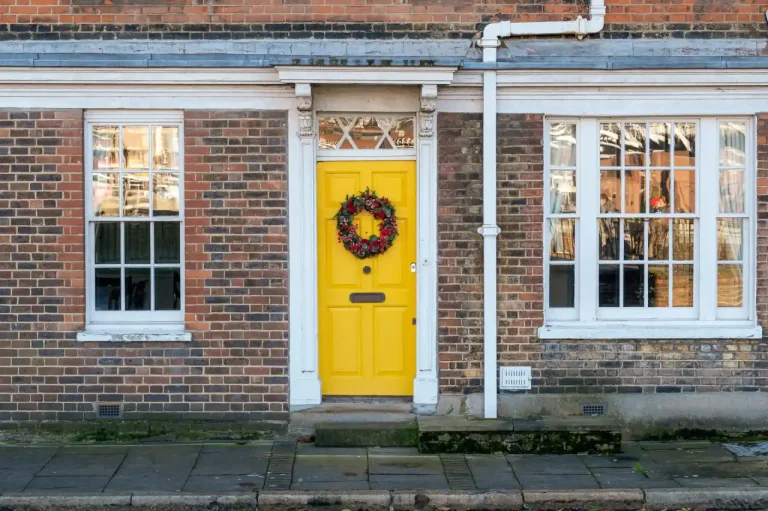 Types of door locks in the UK – yellow front door on a red-brick Victorian house in Wilmslow, Locksmith Wilmslow guide to identifying your lock